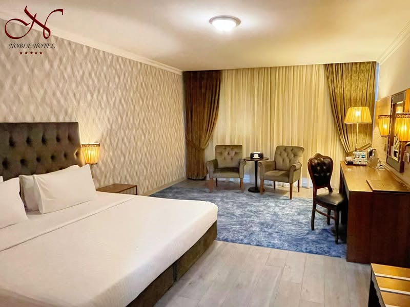 A luxurious suite with a king-sized bed, living area, and modern amenities